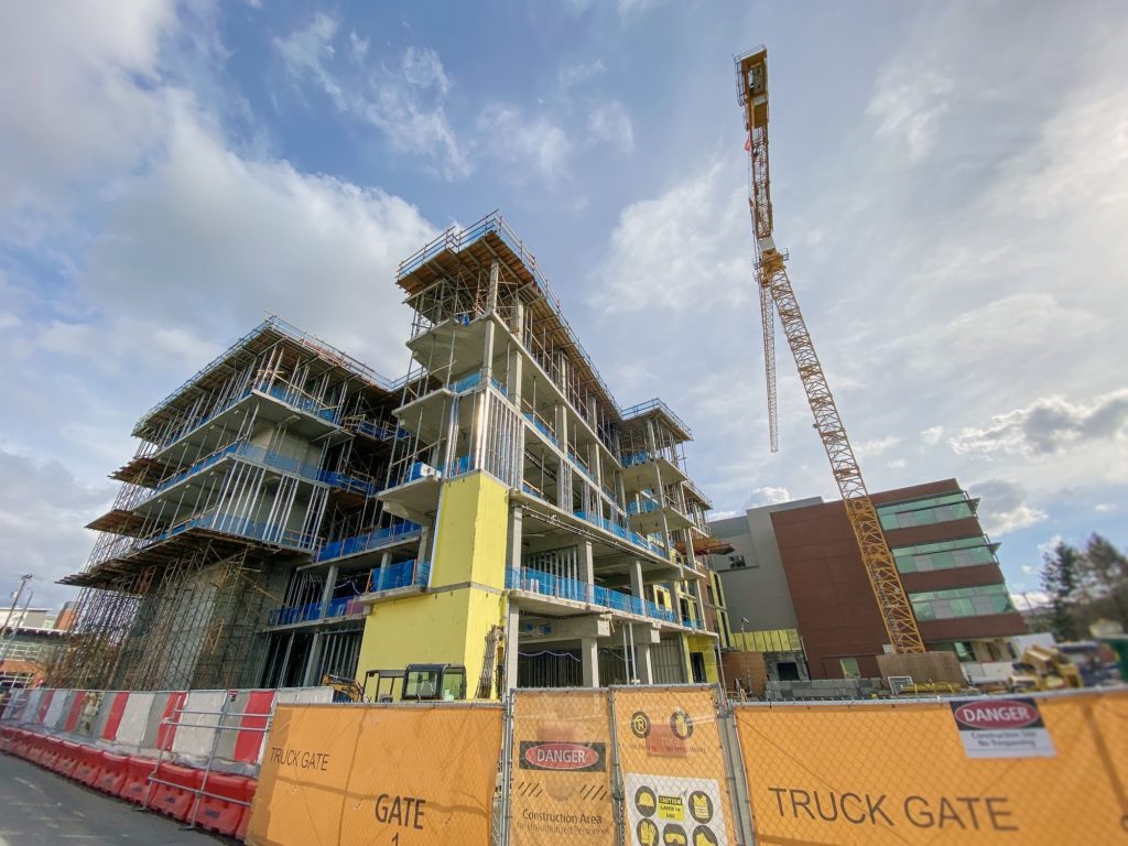 Wide angle looking up at a new wing being built at a construction site